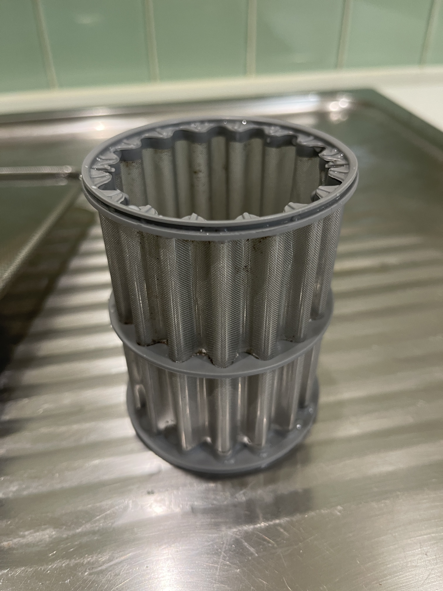 A dishwasher drain pump filter after a deep clean.