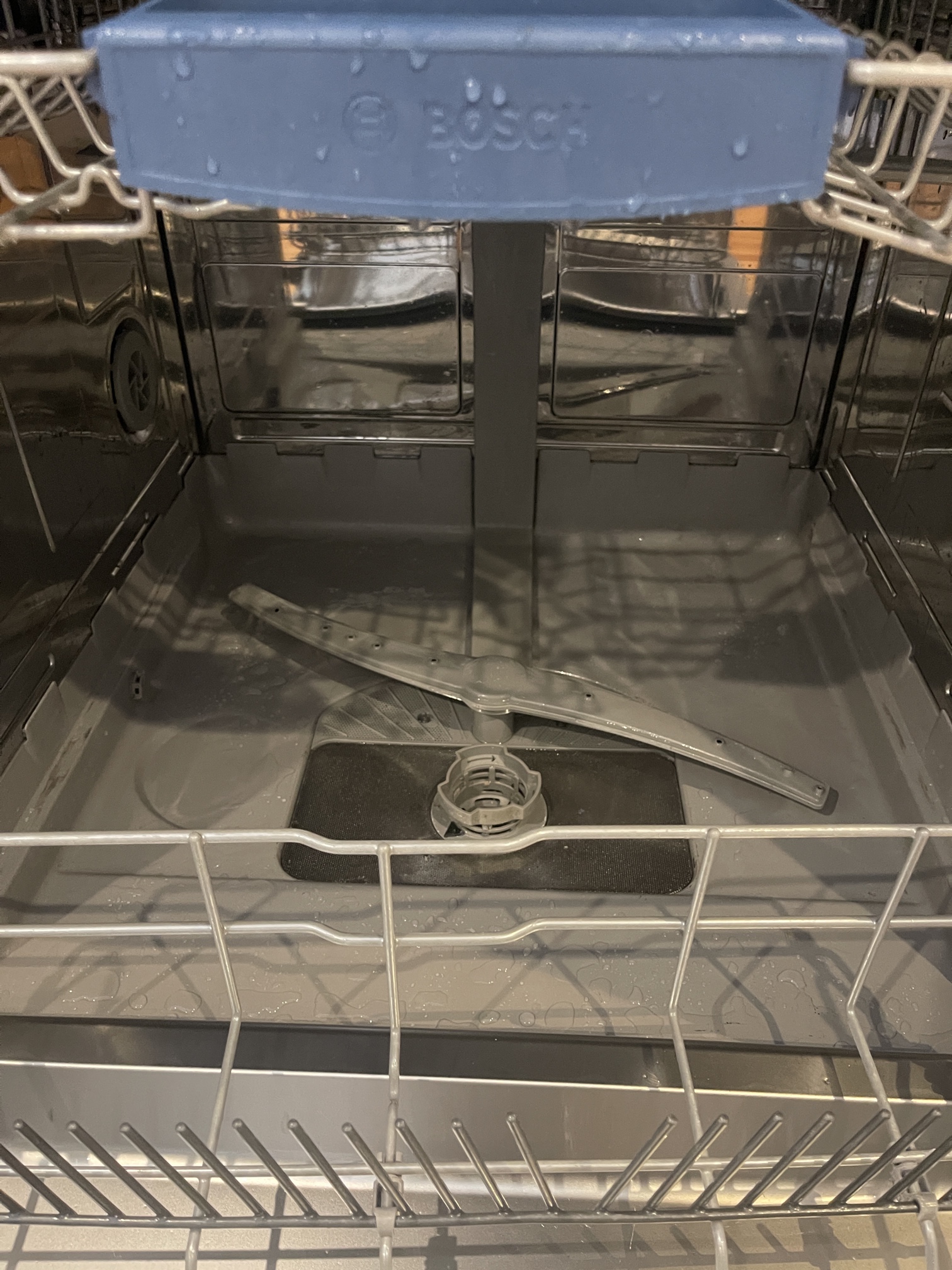 The inside of a dishwasher tub after an Encore Service clean — sanitised, no residue, no odour.