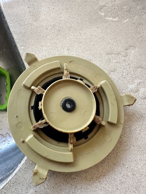 A damaged washing-machine motor rotor exposed during repair.