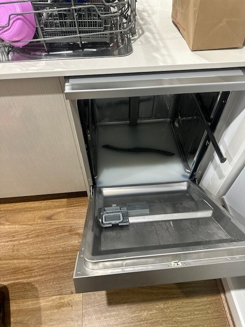 Blocked dishwasher requiring cleaning and repair